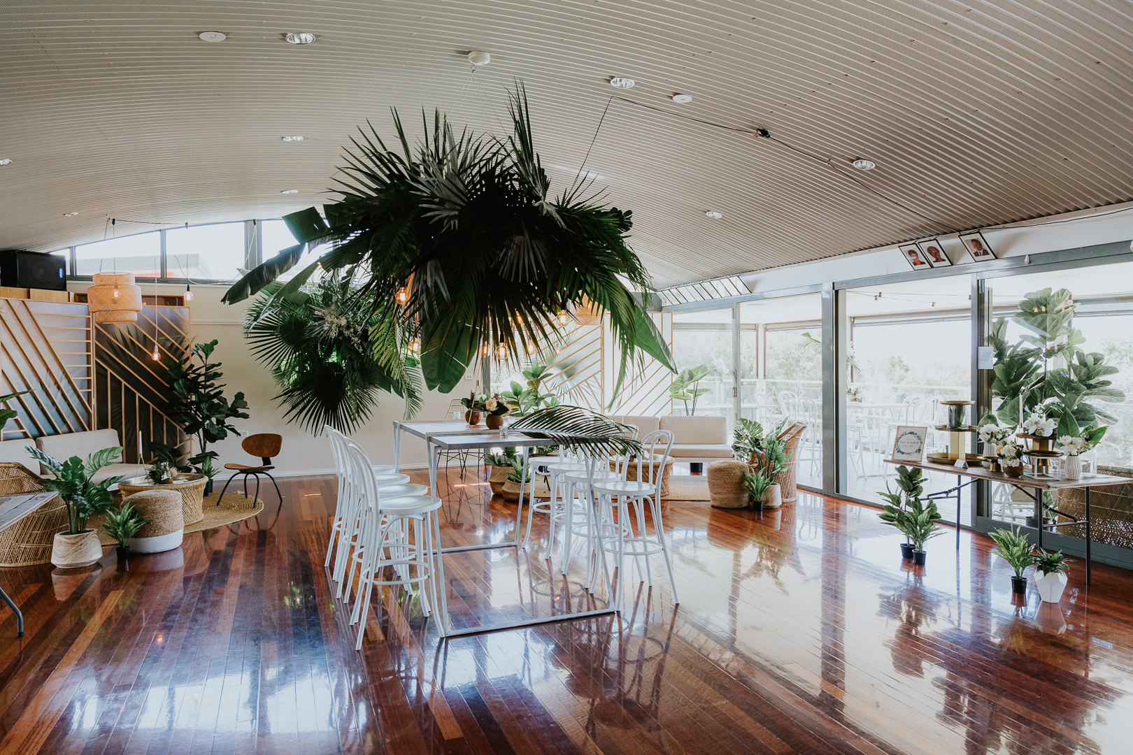 Pacific Palms Surf Club is decorated with a tropical stylning with large monstera leaves